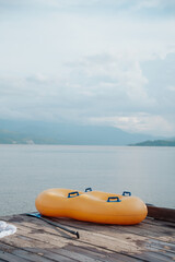 Fototapeta premium double inflatable float on a dock on a beautiful lake surrounded by mountains