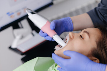 Young asian female receiving dental treatment with modern equipment technology 3D scanner