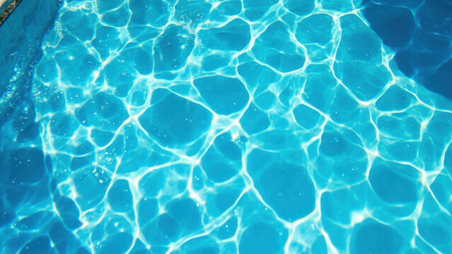 Abstract view of shimmering water in a swimming pool on a sunny day - Powered by Adobe