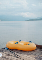 Fototapeta premium double inflatable float on a dock on a beautiful lake surrounded by mountains
