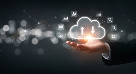 Hand holding a glowing cloud icon with upward and downward arrows, symbolizing cloud computing and data transfer, against a dark background with bokeh lights