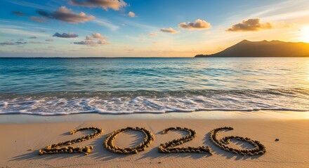 New year 2026 written in the sand on a tropical beach at sunset