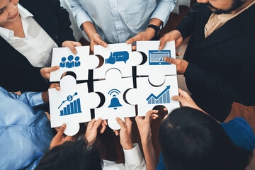 A diverse team collaboratively assembles puzzle pieces, each representing key business concepts...