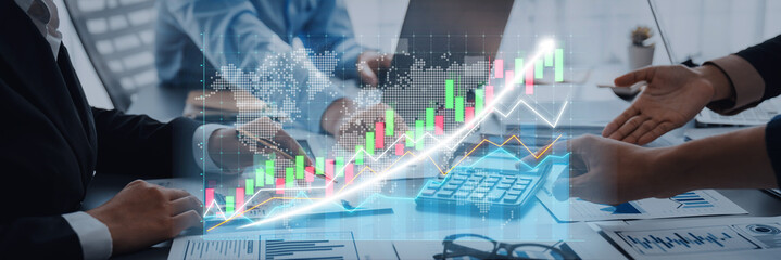 A professional business team engages in a strategy discussion, analyzing digital graphs and charts to drive financial growth and successful outcomes. Axiom