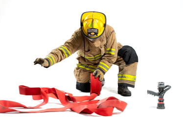 Naklejka premium Portrait of a firefighter in protective uniform holding a firefighting and fire hose nozzle