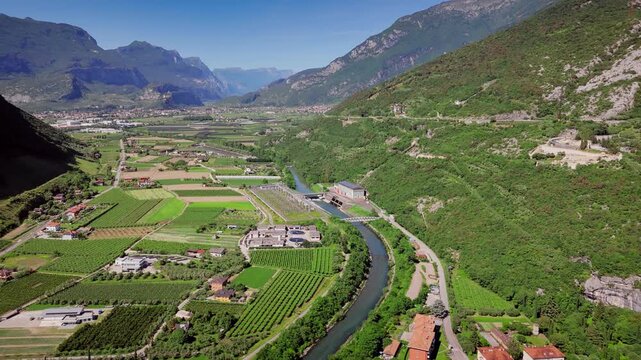 Torbole town on Lake Garda shoreline and mountainous backdrop, Aerial drone shot