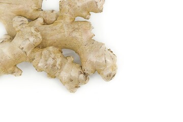Organic ginger root placed on white surface with detailed texture.