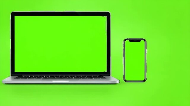 Modern laptop and smartphone with bright green screen chroma key backgrounds isolated on vibrant