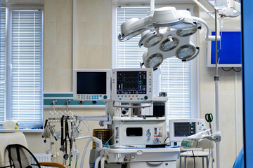 A hospital operating room with a lot of equipment in it