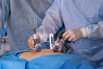 A surgeon is performing an operation on a patient