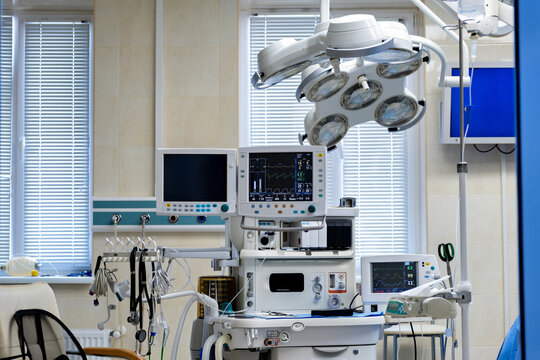 A hospital operating room with a lot of equipment in it