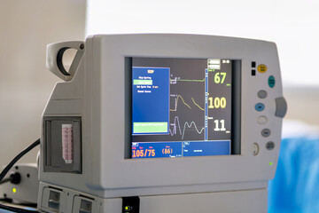 A medical device sitting on top of a hospital bed