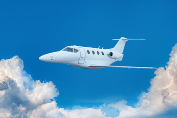White bizjet fly in the blue sky