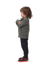 side view of a  boy dressed in sportswear arms crossed on a white background
