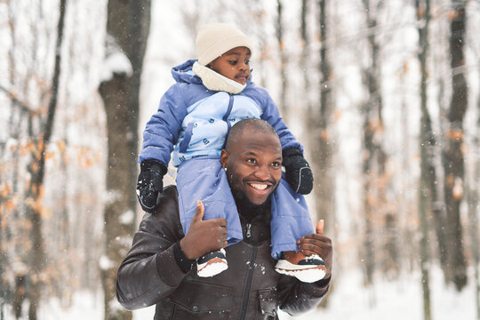 father and child boy in winter forest with parents and kids love relationship having warm clothes for cold climate