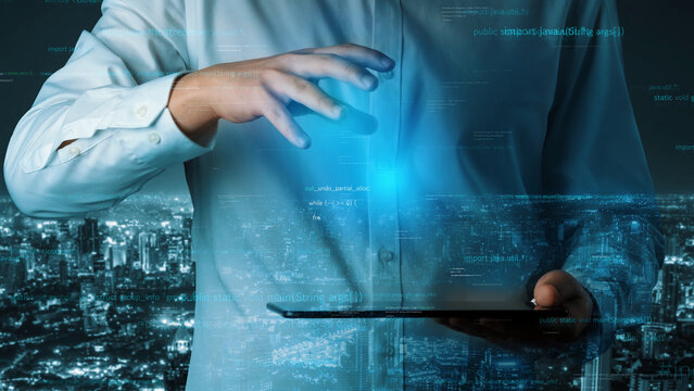 A businessman engages with a tablet, showcasing futuristic technology amidst a glowing cityscape, representing digital innovation and connectivity in business. Xenic - Powered by Adobe