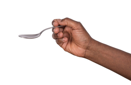 Hand holding a stainless steel tablespoon isolated on white or transparent background