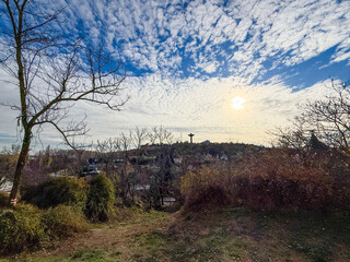 Obraz premium Sunlit village landscape with dramatic cloudscape 