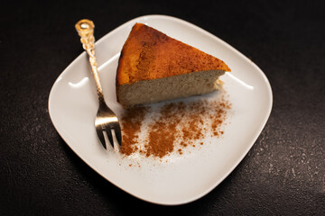 Top view of vegan cheesecake on plate with small fork.