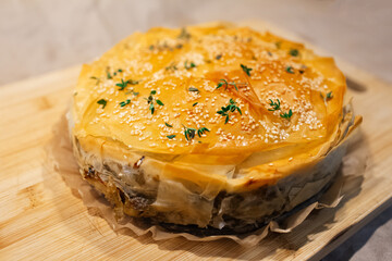Close-up of vegan Serbian burek on board.