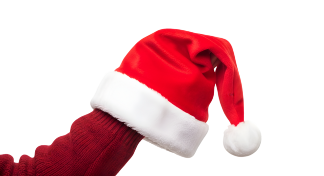 Human hand holding a soft red Santa Claus hat with white fluffy trim, isolated on white background, cozy festive clothing.