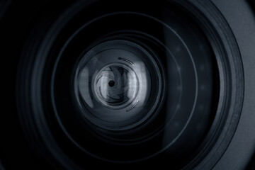 Black camera lens with light reflections