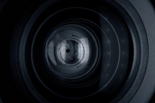 Black camera lens with light reflections