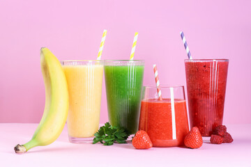 Different tasty smoothies in glasses and ingredients on pink background