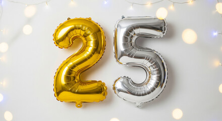 Gold and silver foil balloons number 25 with festive bokeh lights