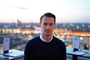 Cool Caucasian man at rooftop bar during blue hour with city lights glow