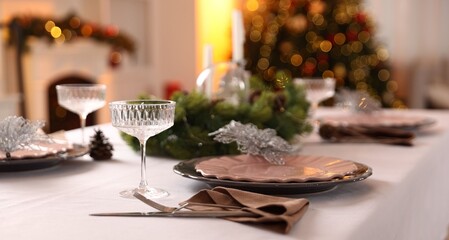 Festive table setting with Christmas decor indoors, closeup