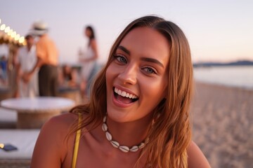 Close-up of a smiling Caucasian woman at a beach party during sunset by the shore