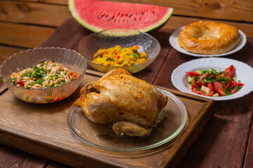Couscous with dried hands and turmeric, grilled whole chicken, flatbread, vegetable salad