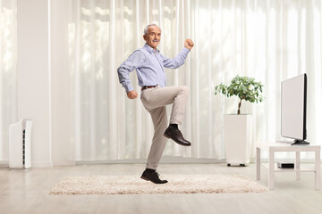 Happy male pensioner dancing