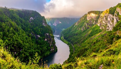Calm river flowing between steep green cliffs