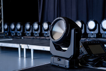 Close-up of a professional stage lighting fixture mounted on a metal truss in studio