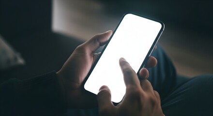 A close-up shot of a person’s hands holding a smartphone with a blank white screen and using their thumb to interact with the display showing a simple interface or application