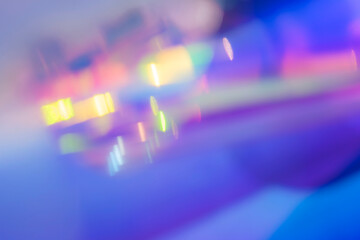 Abstract Neon Bokeh Of Blurred Lights On Metallic Foil Surface With Purple And Blue Hues