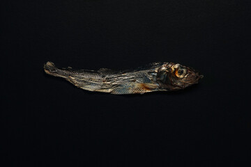 Dried Sprat Fish on Black Background: Textured, Minimalist Snack, Gourmet Seafood Visual for Still Life