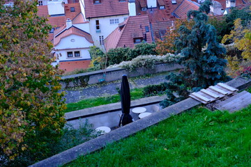 An autumn panoramic view of historic Prague with red rooftops