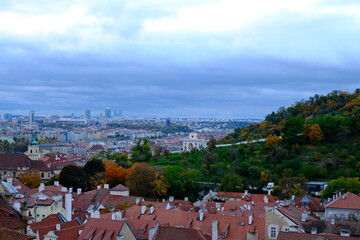 An autumn panoramic view of historic Prague with red rooftops