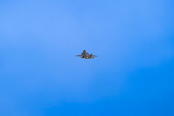 Photograph of a high-powered Jet aircraft flying at speed in regional Australia