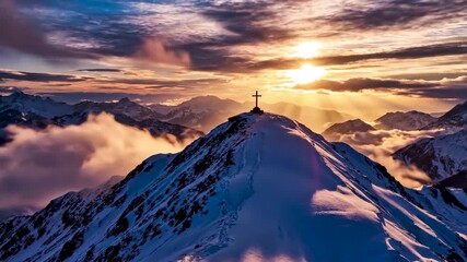 Majestic mountain peak with a cross silhouetted against a vibrant sunset in the alps aerial view - Powered by Adobe