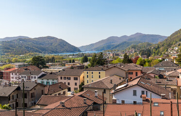 Obraz premium Panoramic view from the village of Bioggio overlooking Lake Lugano and the surrounding mountains in the canton of Ticino, Switzerland.