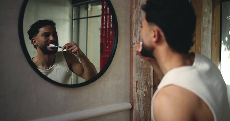 Bathroom, man or brushing teeth by mirror for wellness, oral hygiene or gum health. Home, person or cleaning with toothbrush with reflection for fresh breath, dental or self care with morning routine - Powered by Adobe
