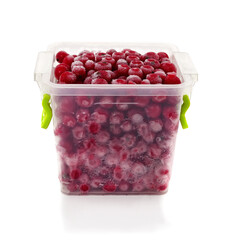 Frozen red berries in plastic container.