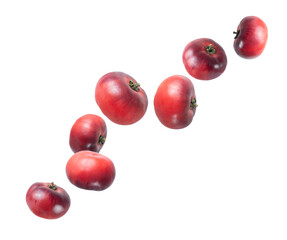 Organic dark red tomatoes in the air close up isolated on a white background