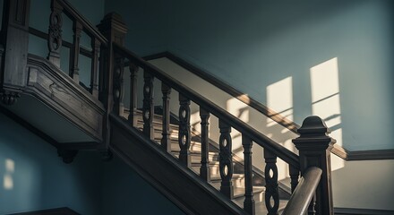Sun-drenched wooden staircase within an aged building, where dramatic shadows are cast upon the vintage blue wall, evoking a profound sense of history and quiet elegance
