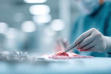 Closeup of a surgeon using tweezers during a delicate procedure, highlighting precision and expertise. Ideal for medical, science, or healthcare themes.