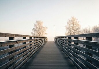 Fototapeta premium Wooden Bridge Path Leading to a Bright Horizon in Early Winter